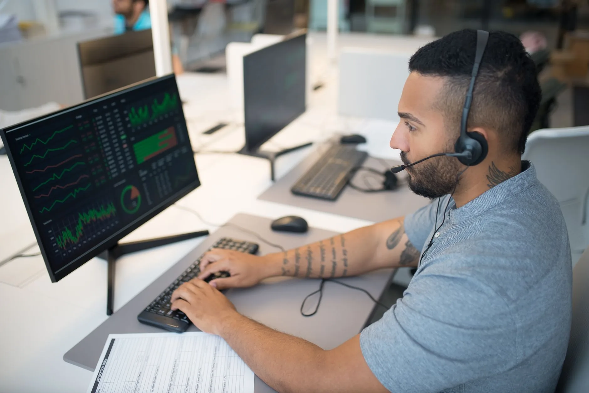 A deserted cybersecurity office with cloud-based email filtering software on screens.