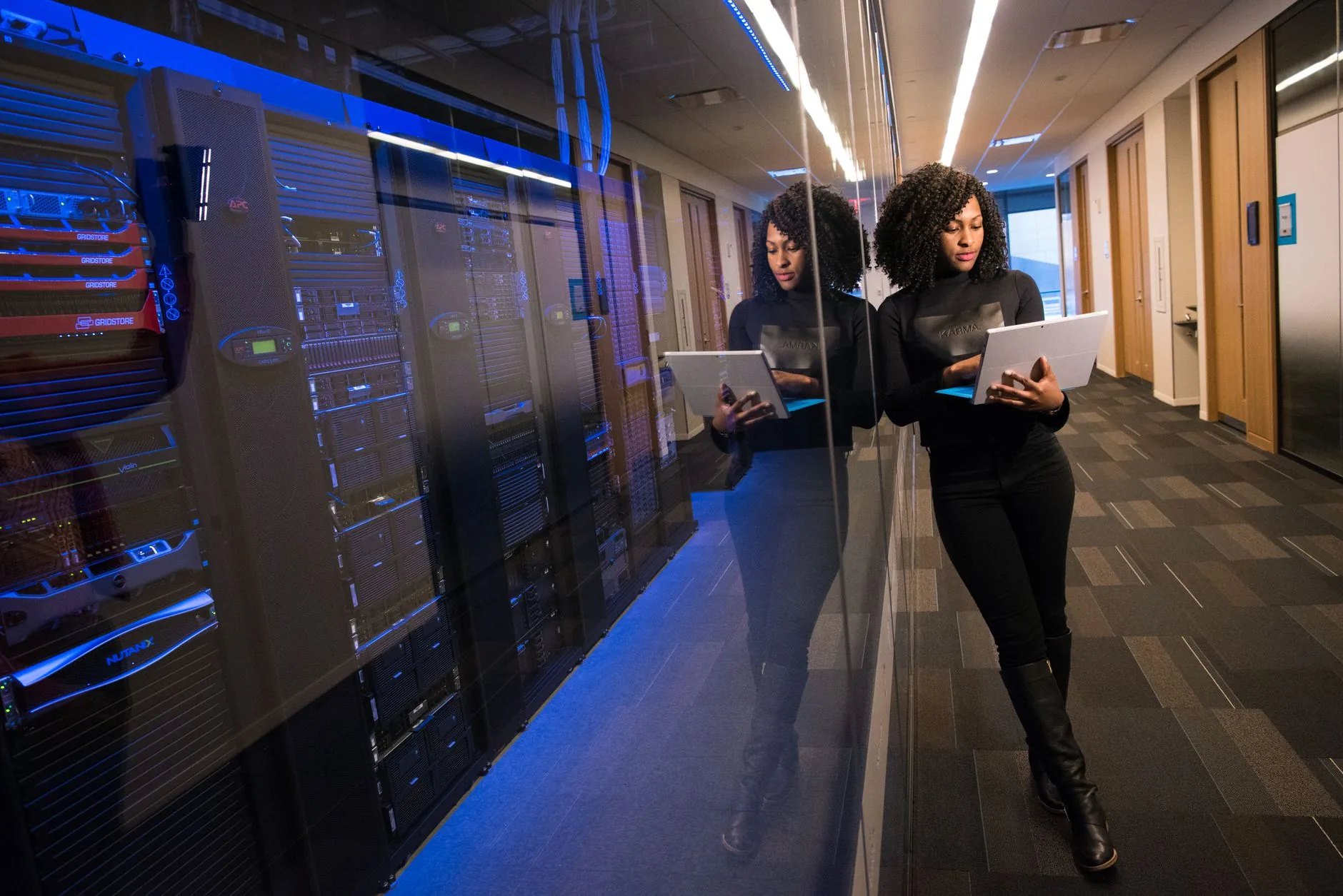 Empty cybersecurity operations center with screens displaying risk assessment data, sample risk register template visibl